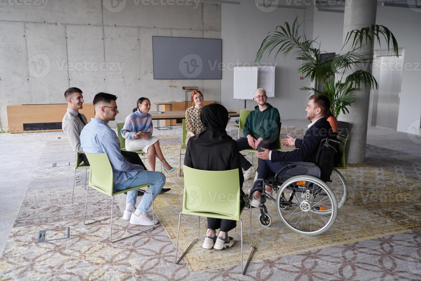 Corporate business team meeting with a manager or coach. Group of happy diverse, multiracial people sitting in a circle photo