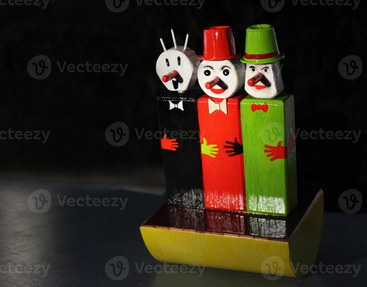 Three wobbling clowns on a black background, Roly poly photo