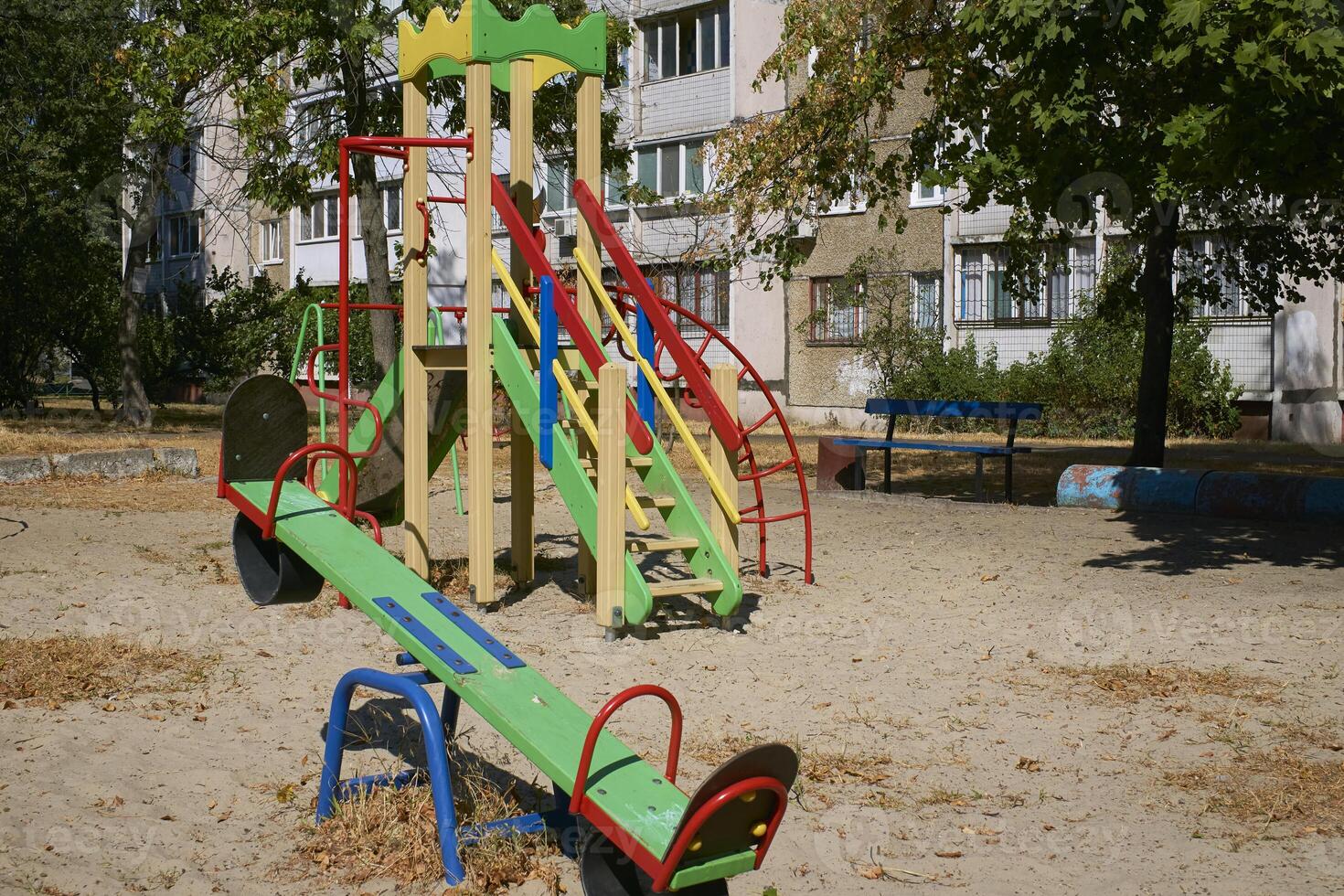 Summer spring children's playground with painted toy slide in park photo
