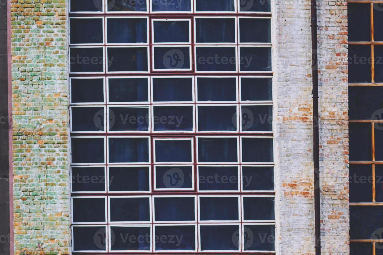 Black window with white frames on vintage old brick wall photo