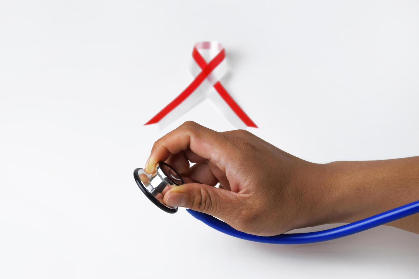 Hand Holding Medical Stethoscope with Ribbon Accent photo