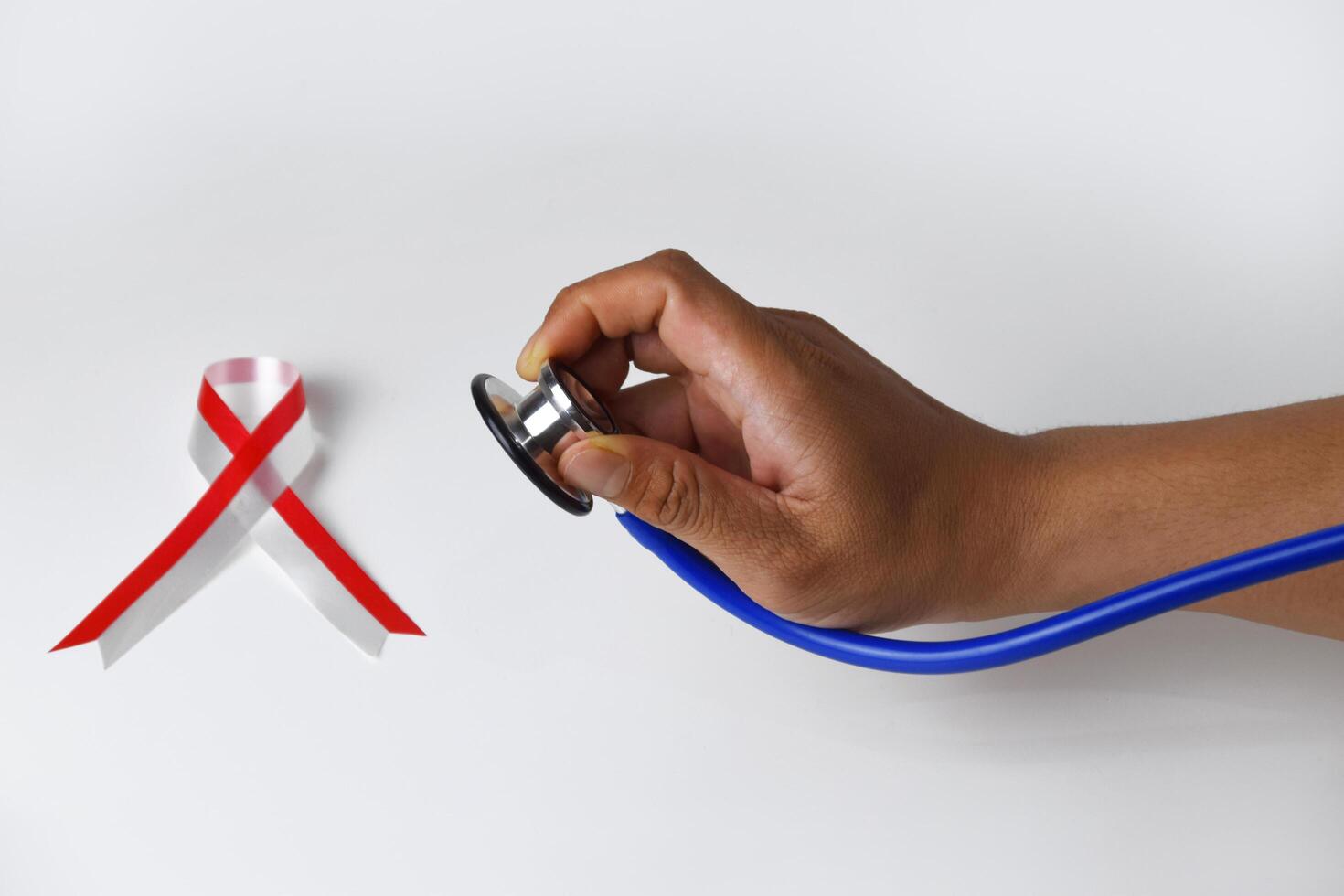Healthcare Awareness Stethoscope and Ribbon in Hands photo