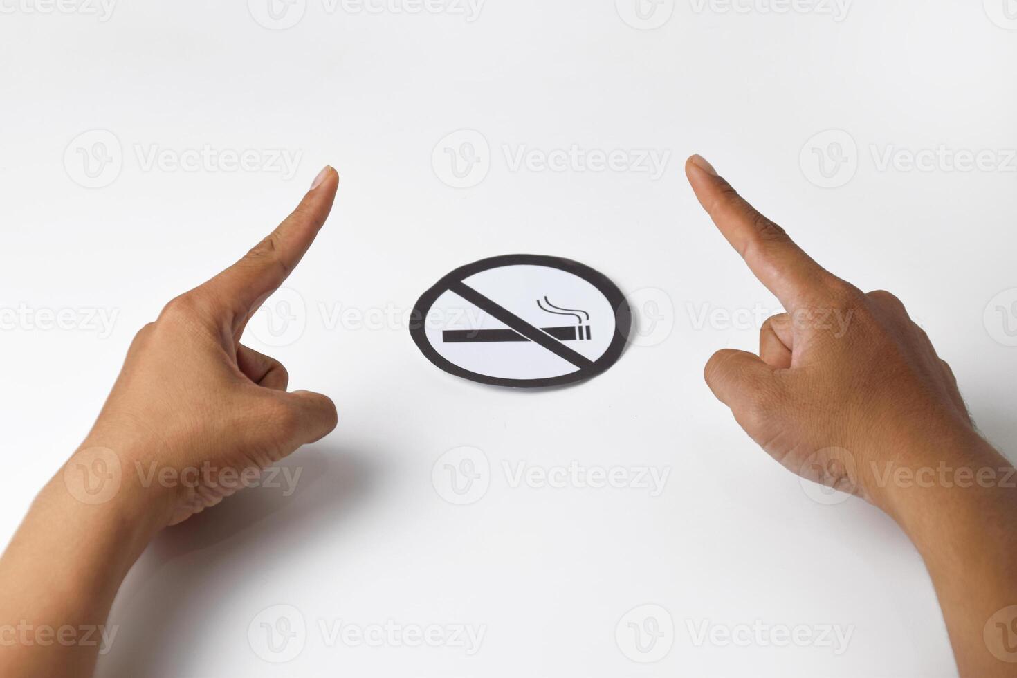 Hands showing warning gesture with no smoking sign photo