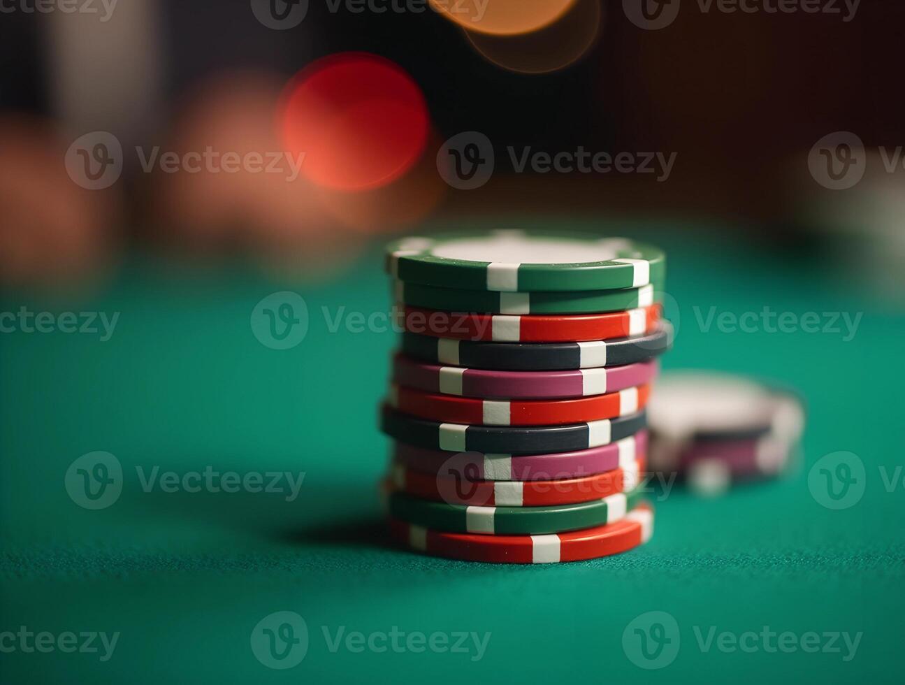 A tall stack of vibrant casino chips rests on a green felt table. Poker game. Group of poker chips on green table, closeup. Gambling concept photo
