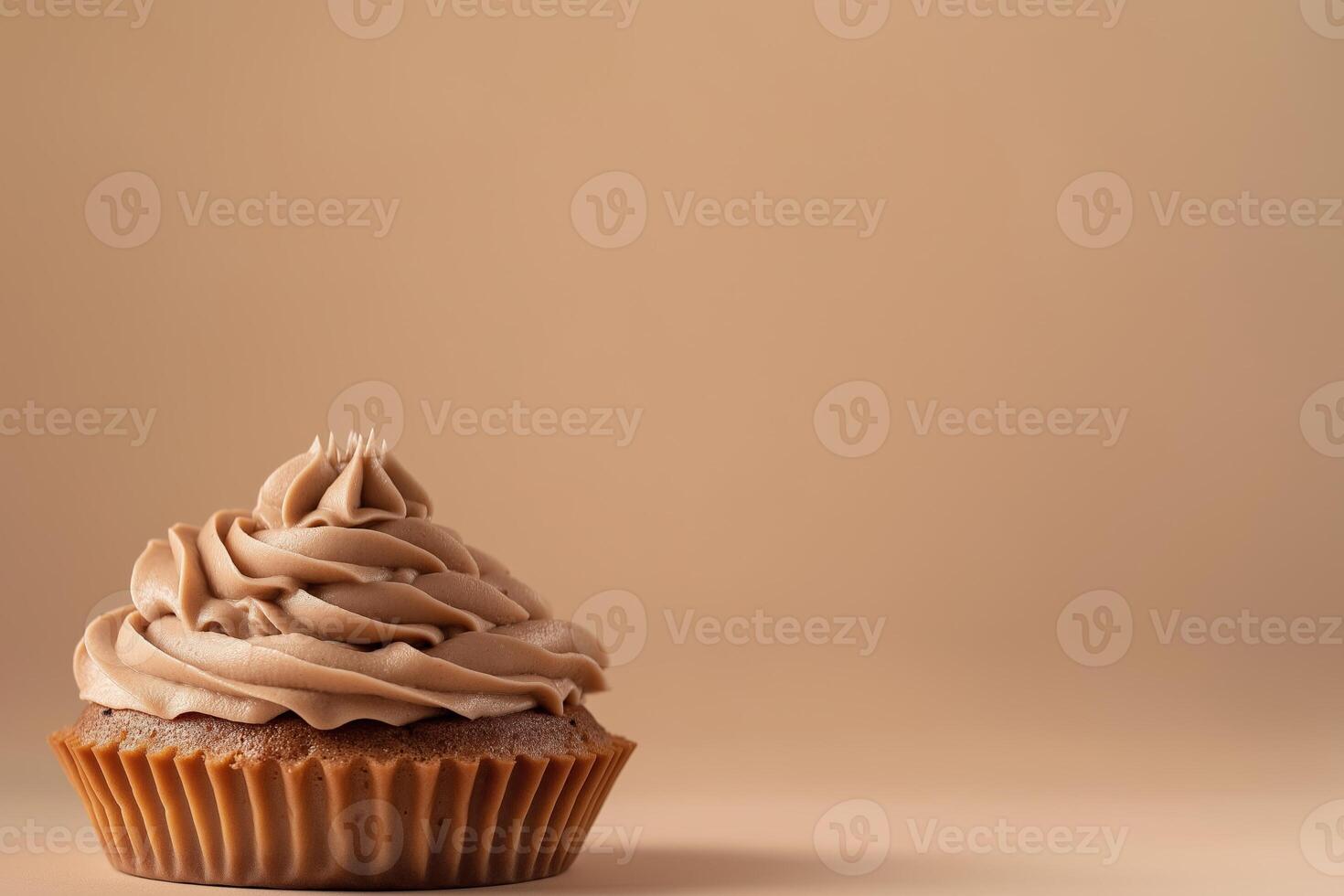 Side view of cupcake with creamy mousse on top, mocha or chocolate mousse dessert with smooth texture, soft brown background. Color trend concept, color of the year 2025. Banner with copy photo