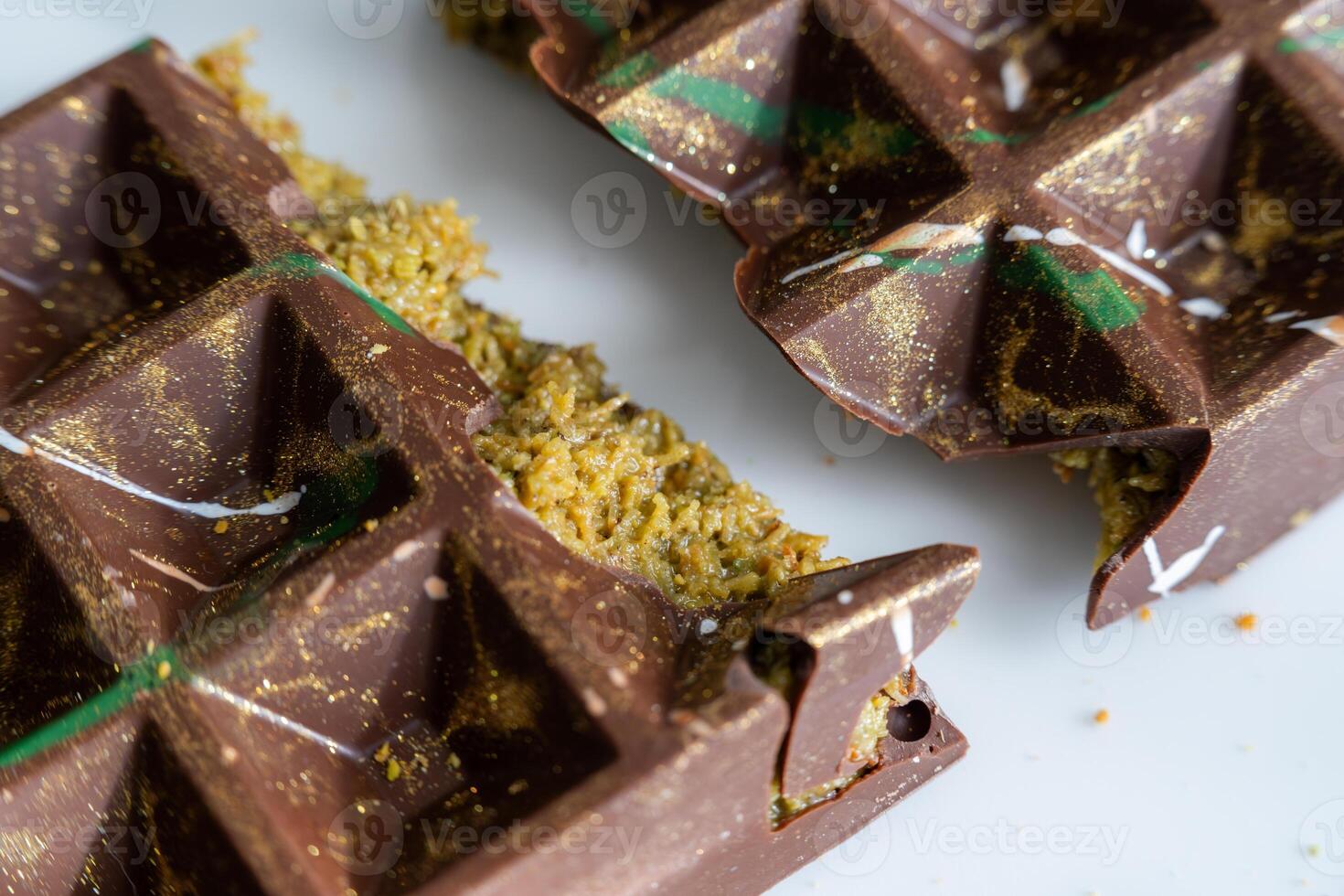 Trend Dubai chocolate bar with pistachio paste, tahini and kataifi dough. Close up. Confectionery and sweets. Handmade. photo