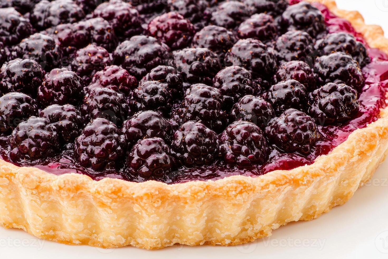 Closeup view of a sumptuous blackberry tart with glistening berries on top, perfectly nestled in a flaky crust. Ideal for a delightful gathering or celebration photo