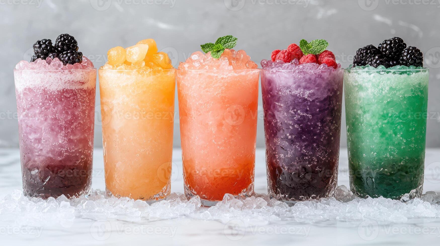 Five colorful frozen drinks in glasses on ice photo