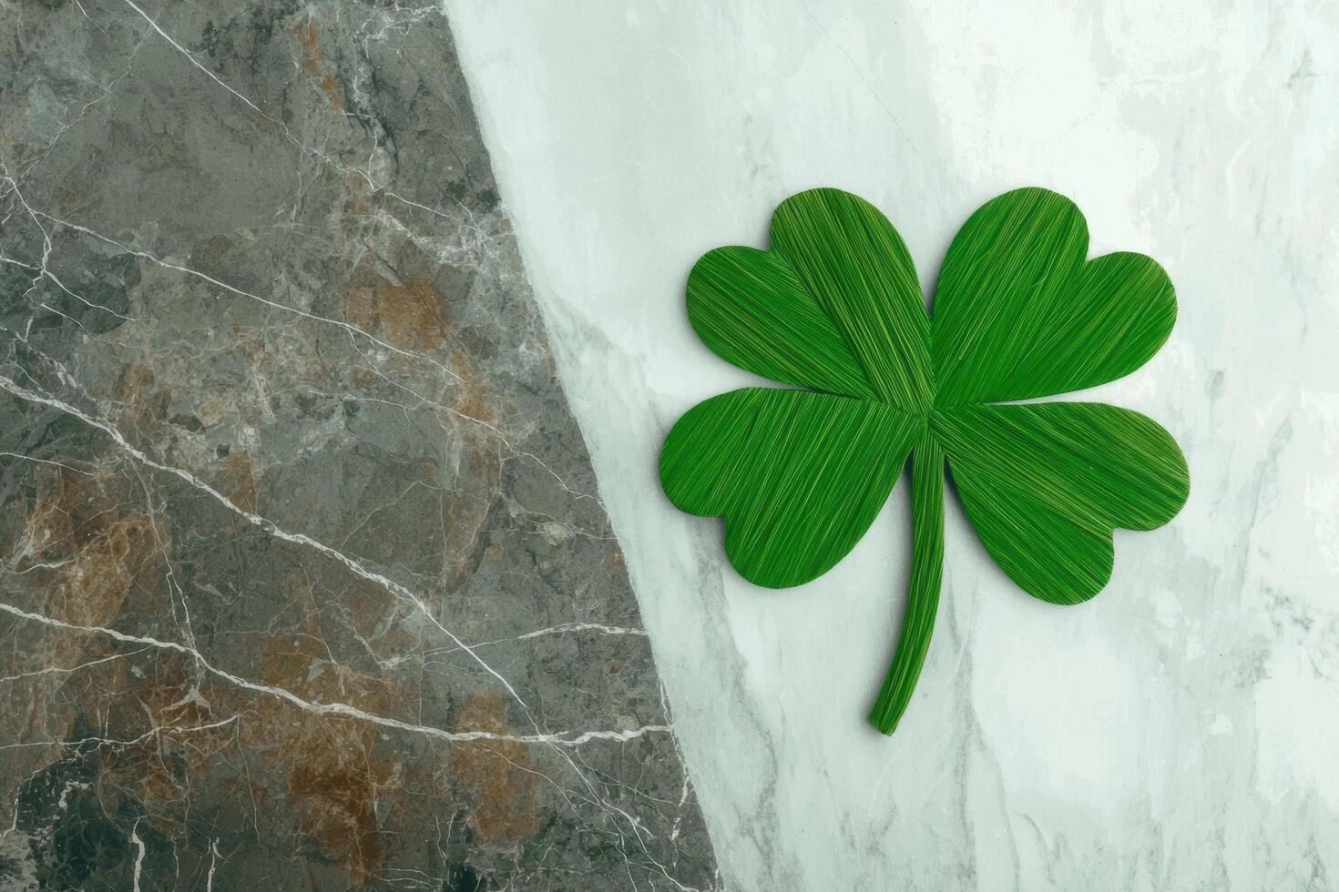 Four leaf clover on marble background photo