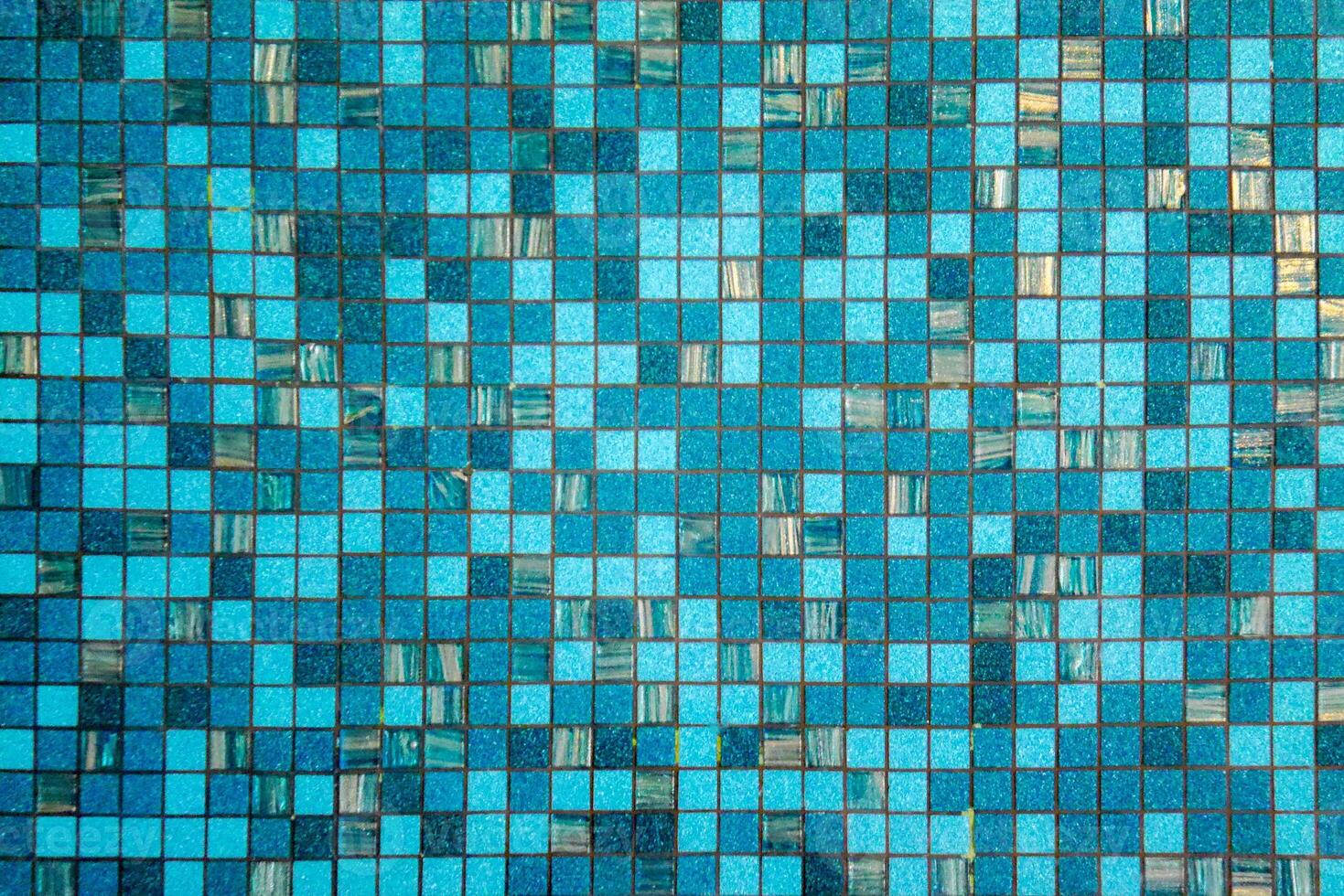 The texture of the blue water ripples in the swimming pool photo