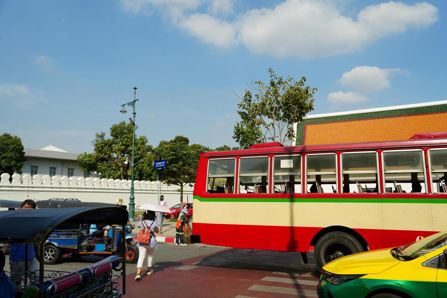 Bangkok, Thailand, 2024 - Traffic in front of Wat Pho, with bus, taxi and tuk tuk photo