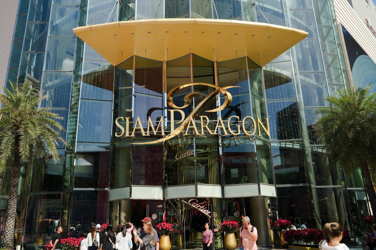 Bangkok, Thailand, 2024 - View in front of Siam Paragon. Crowd of people walking in front of Siam Paragon. Siam Paragon Shopping mall. It is one of the biggest shopping centres in Asia. photo