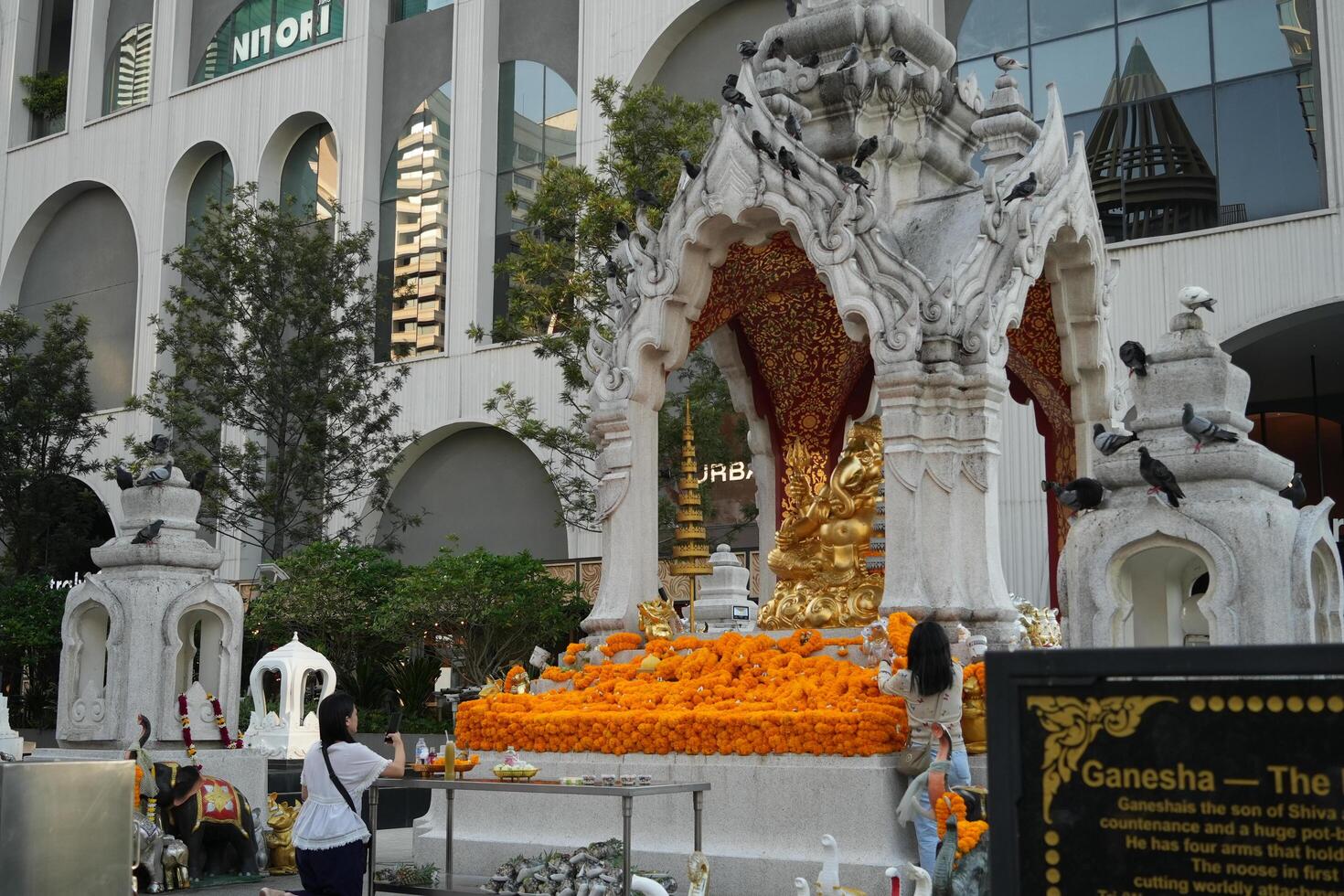 Bangkok, Thailand, 2024 - People pay homage to Ganesh in front of central world plaza in Ratchaprasong area. Ganesha shrine is one of sacred item in Ratchaprasong area. photo