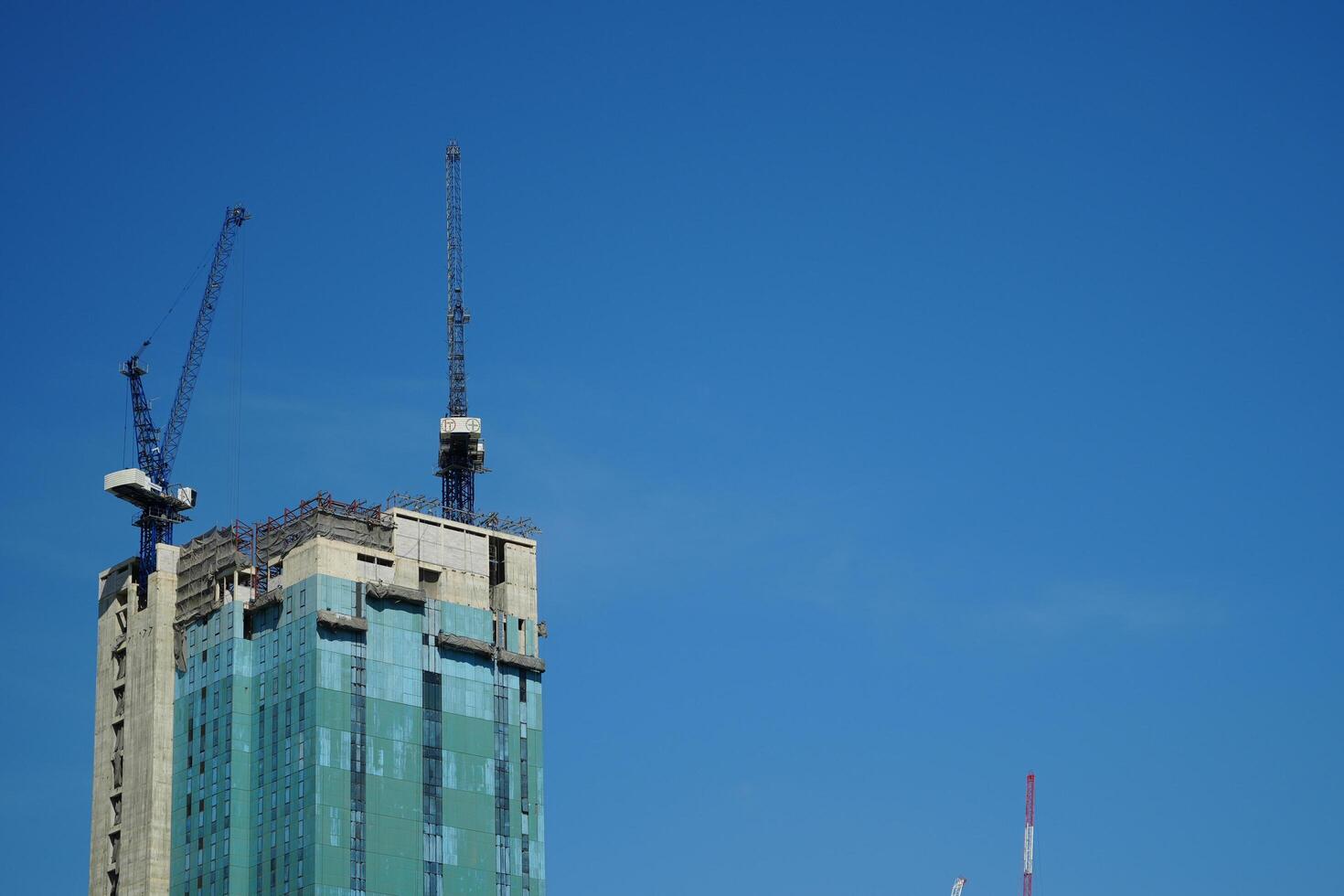 Bangkok, Thailand, 2024 - construction of tall buildings, skyscrapers of bangkok, thailand. on blue sky background photo