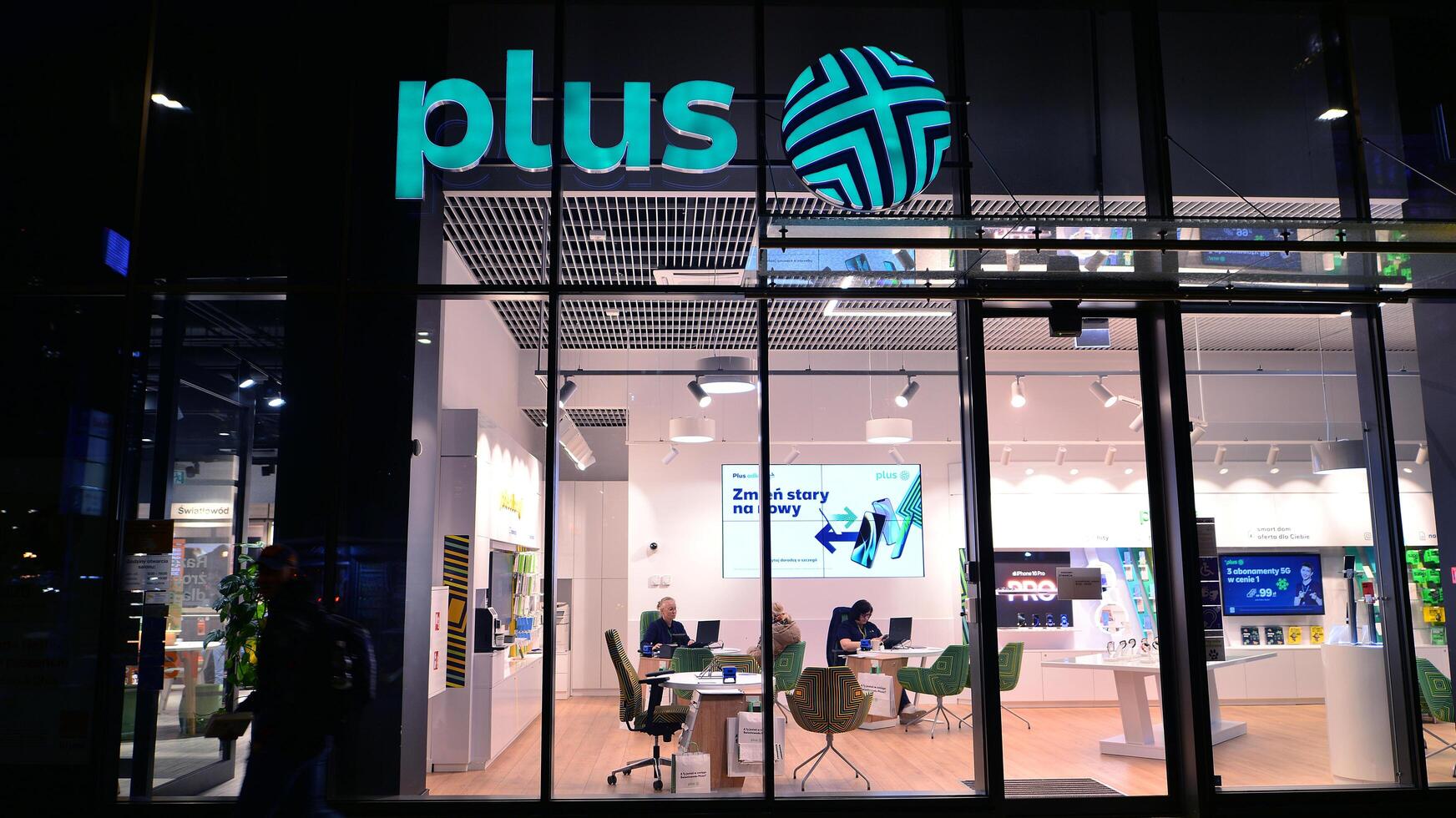 Warsaw, Poland. 22 November 2024. Store front and sign of a store of Plus selling phones and network subscriptions. photo