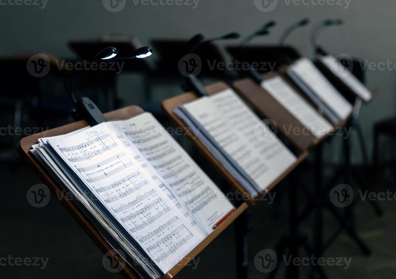 Music stands with musical notes in the rehearsal room. The music stands have lanterns attached to them for lighting photo