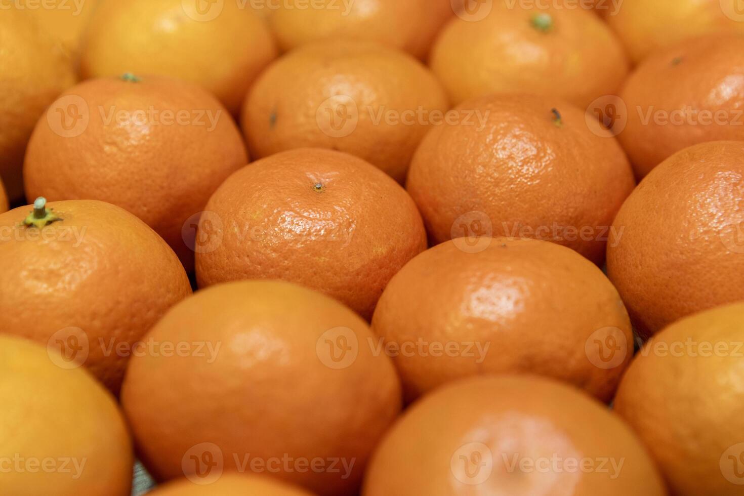 Lots of fresh juicy tangerines in their peels photo