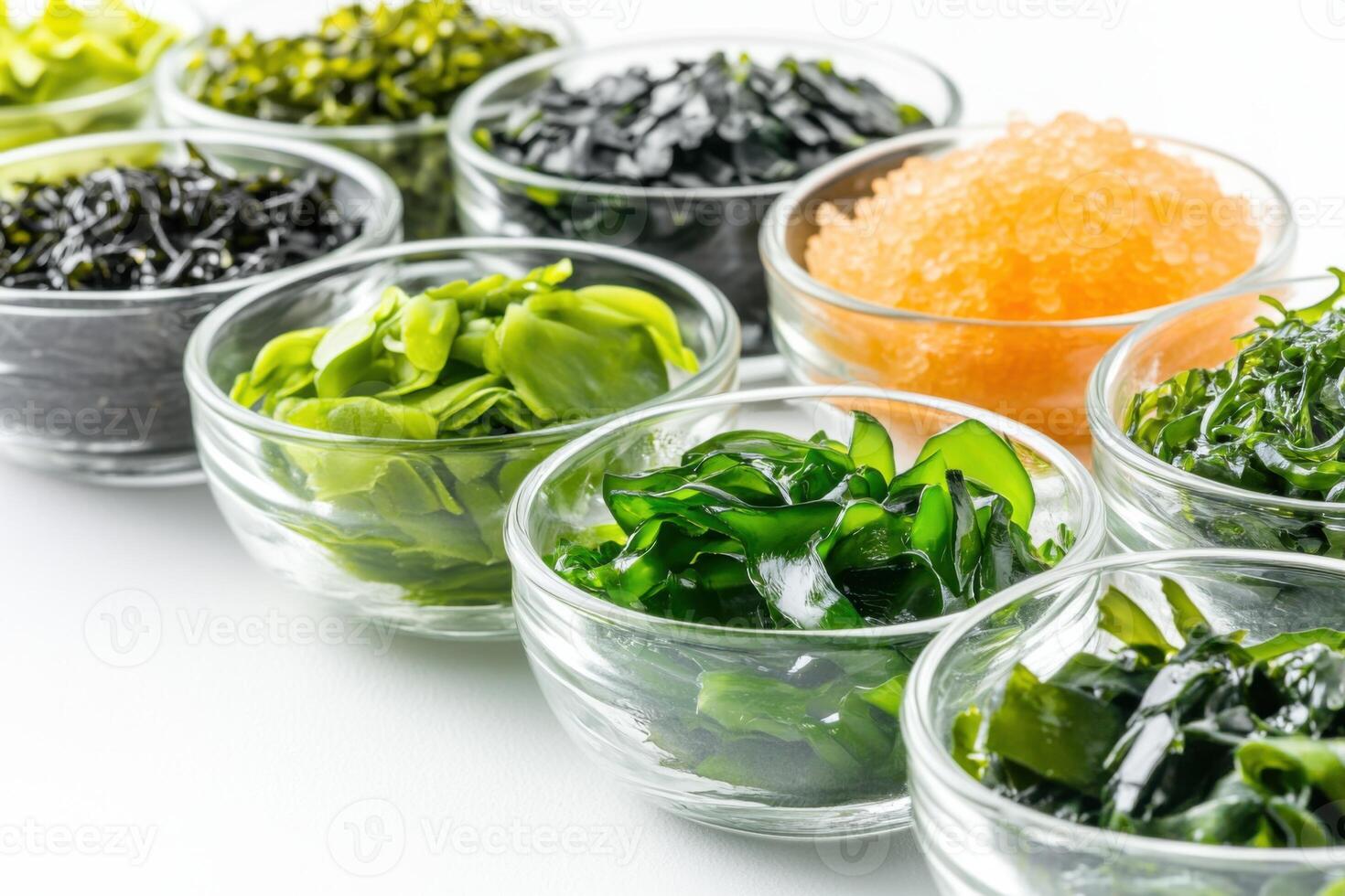 Vibrant seaweed varieties displayed in glass bowls on a white surface for a clean and nutritious wellness theme photo
