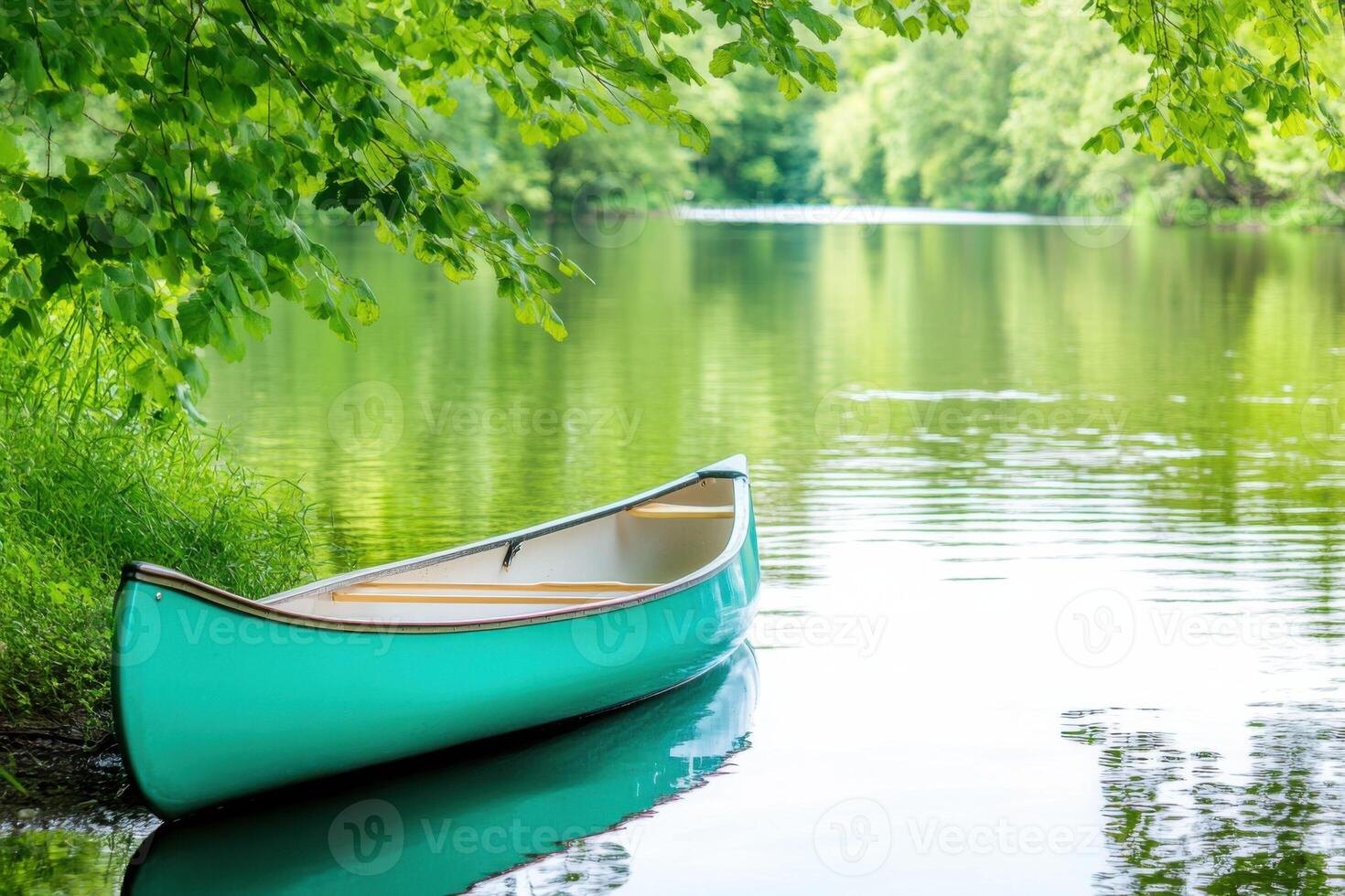 Turquoise canoe resting peacefully along a serene riverbank surrounded by lush greenery and calm reflective waters in nature photo
