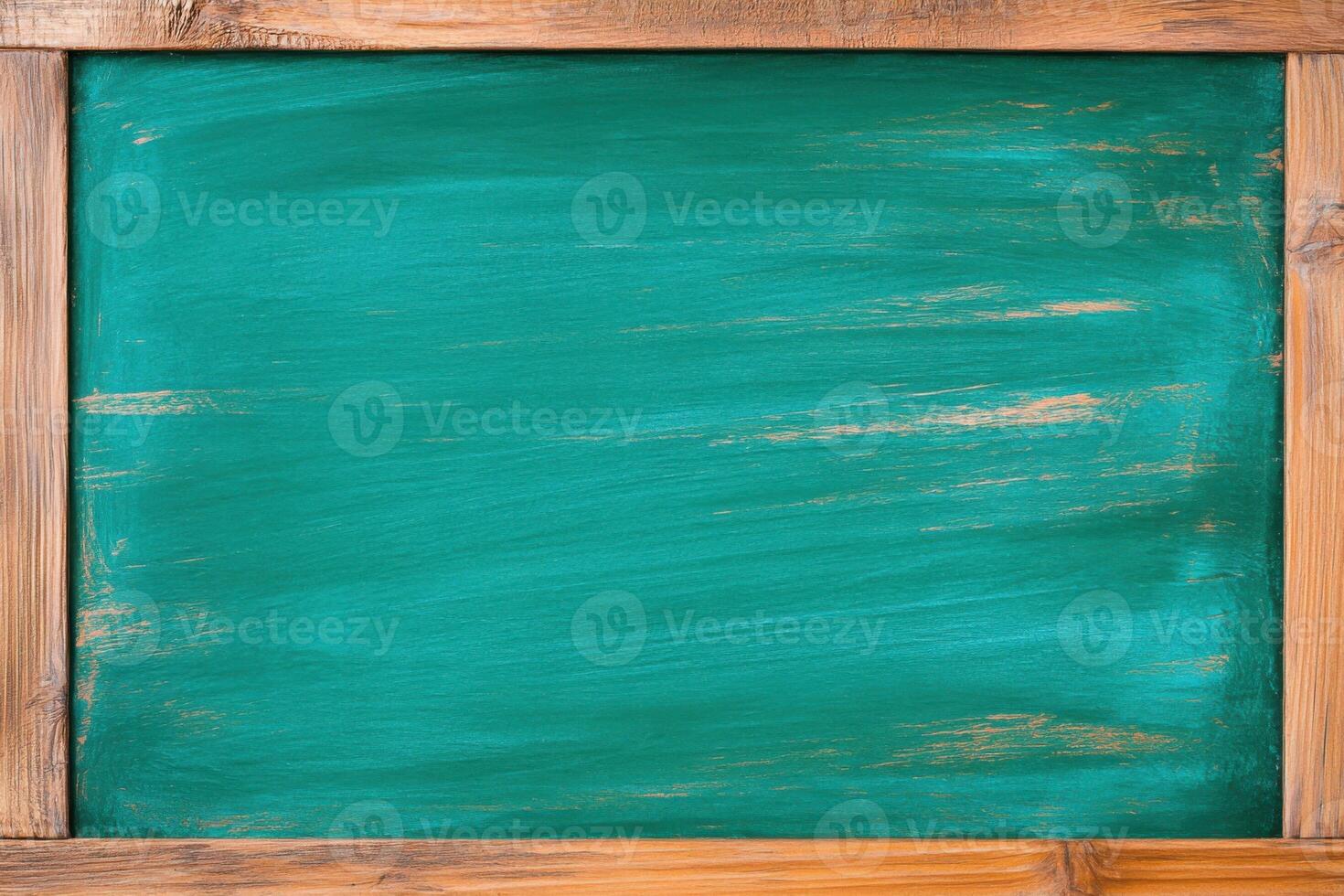 Chalkboard with olive-green background and warm brown wood trim in a simple classroom setting for creative presentations or notes photo