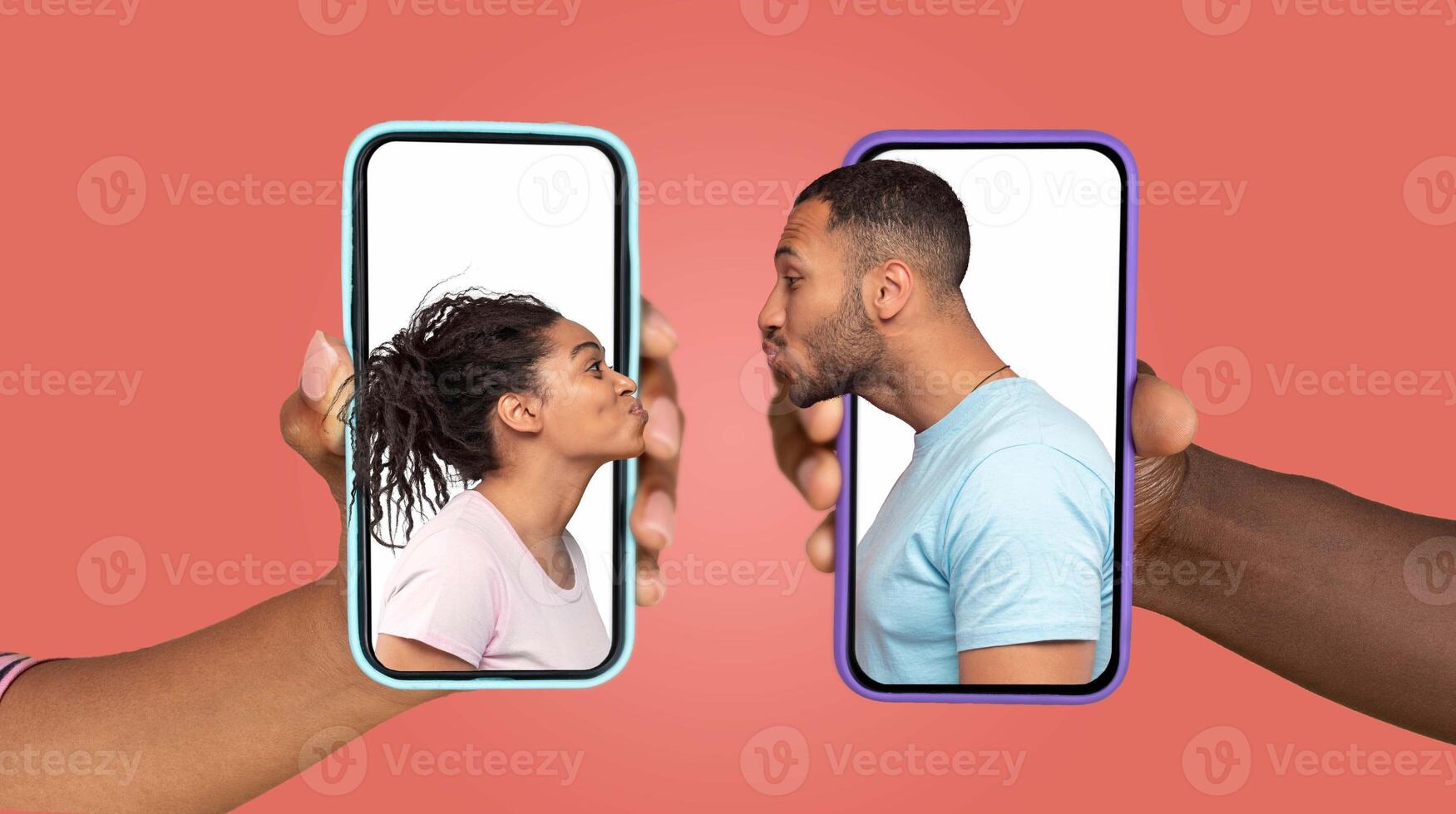 Two people express love and connection while using smartphones. Handheld devices show their faces, emphasizing their online communication and affection in a contemporary relationship. photo