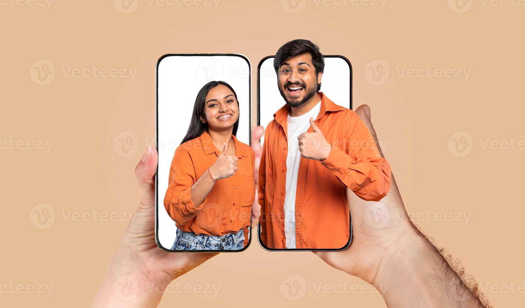 A happy couple shares an affectionate moment as they connect online by chatting on their smartphones. Their expressions showcase love and togetherness, highlighting modern relationships. photo
