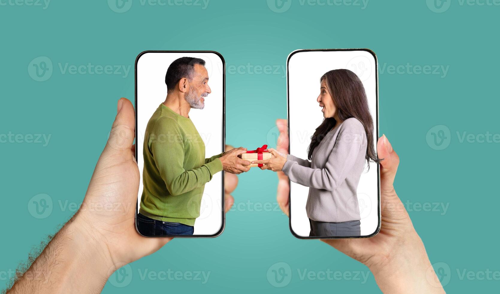 A couple shares a joyful moment as they exchange gifts through a smartphone application. Their hands hold the phones while they engage in a lively chat, illustrating their love. photo