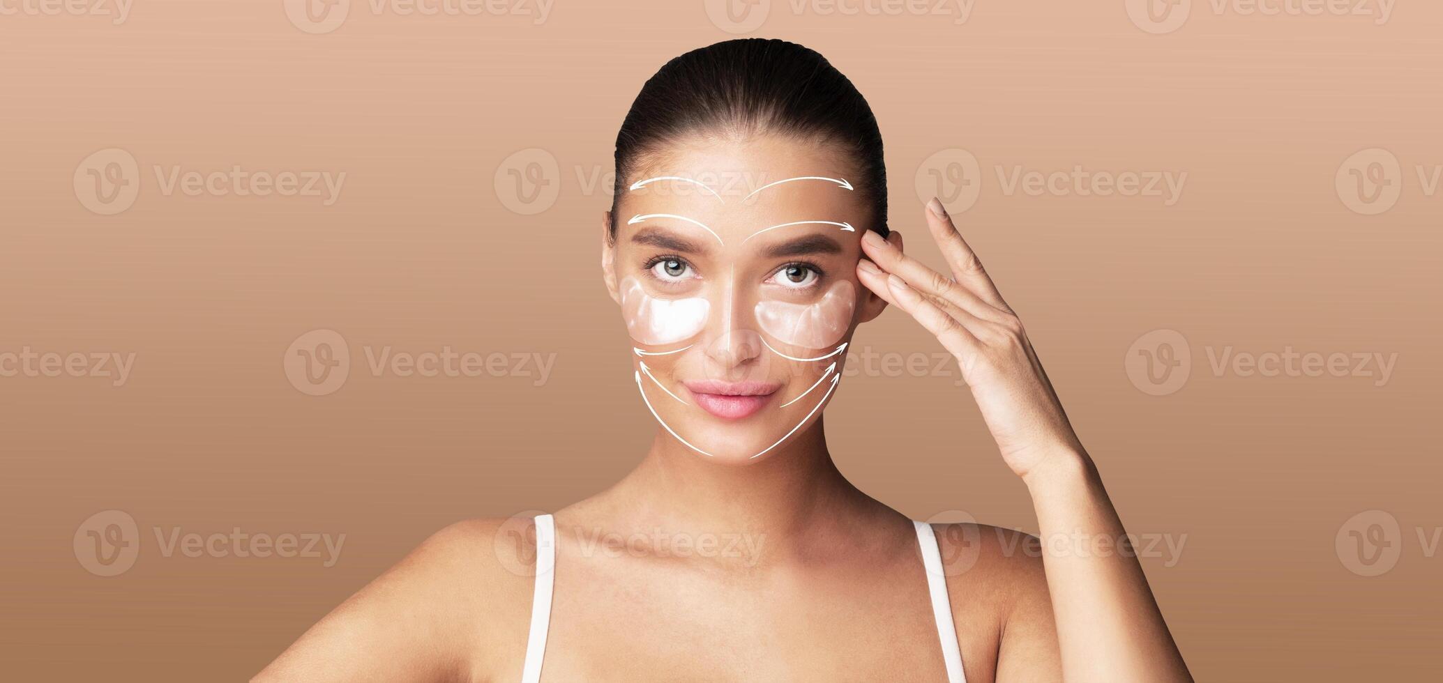 A woman engages in a skin care routine, applying products to her face with a gentle touch. She enjoys a moment of self-care in an isolated, tranquil setting, perfect for relaxation and beauty. photo