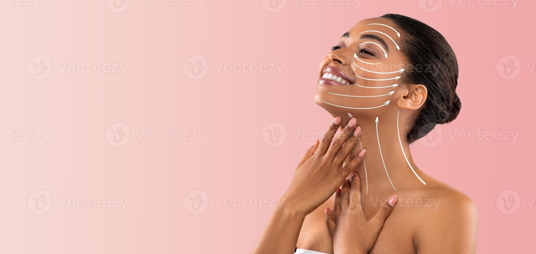 African American woman enjoys a soothing skincare routine, gently applying products to her face. She smiles, radiating confidence and relaxation in an empty, soft-toned space, perfect for self-care. photo