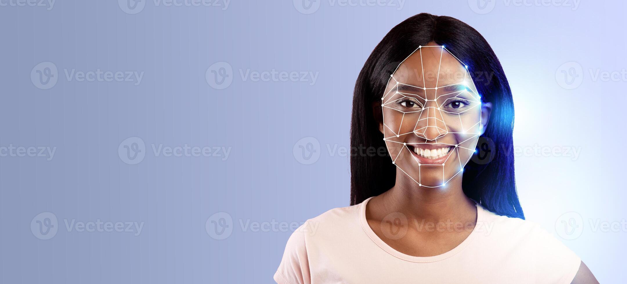 A young woman is smiling while her face is scanned by advanced facial recognition technology. photo