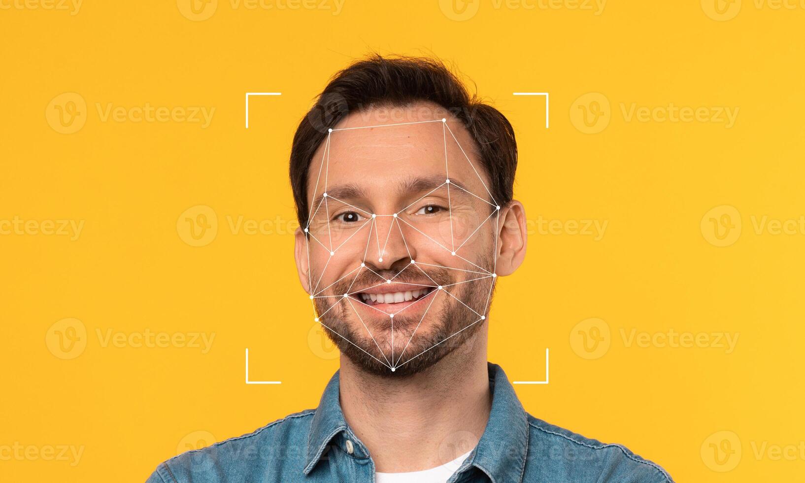 An individual stands against a bright yellow background, showcasing facial recognition technology. Geometric lines outline his facial features, emphasizing identity and technology. photo