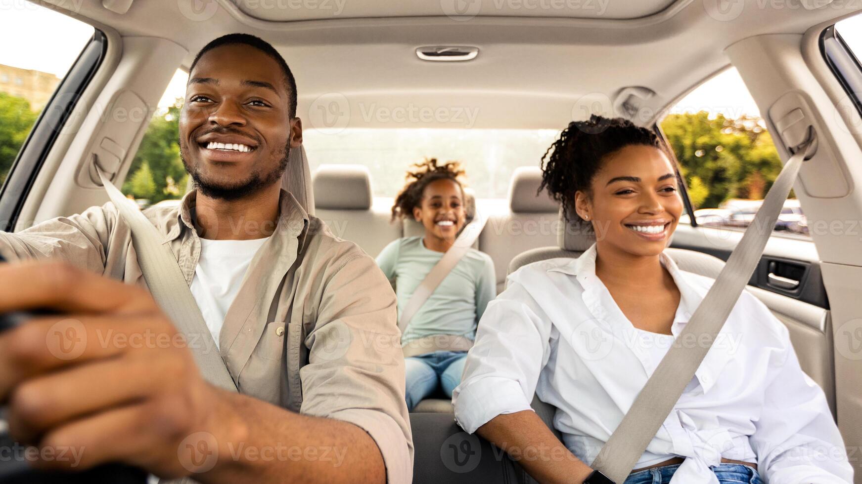 Car Sales. Cheerful African American Family Riding New Automobile Traveling On Vacation. Happy Parents And Daughter Enjoying Road Trip In Summer. Transportation And Vehicle Purchase photo