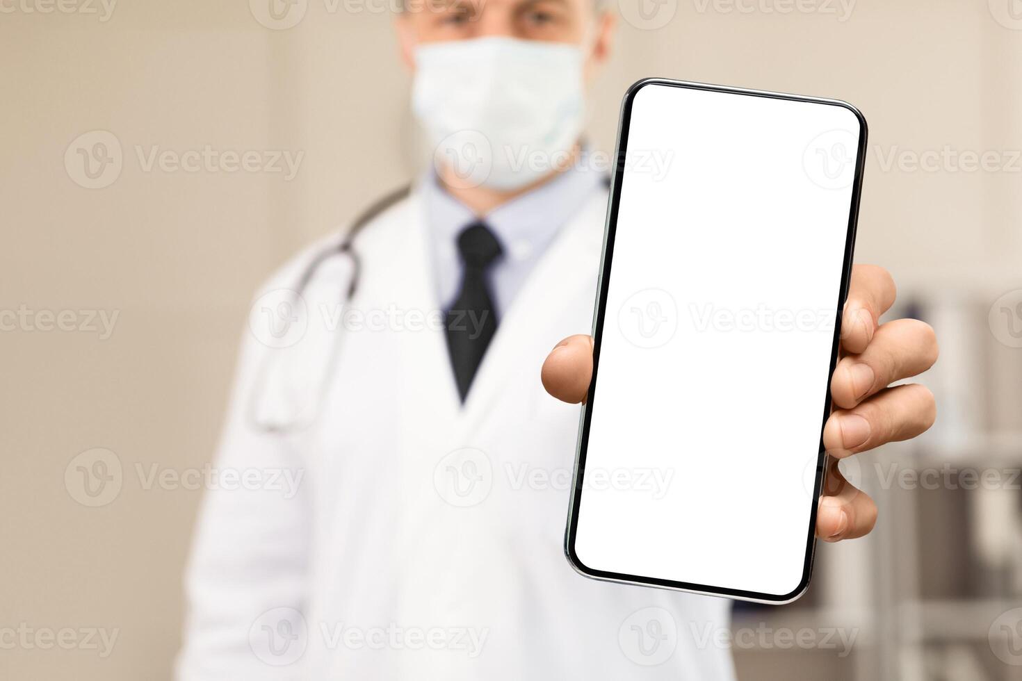 Be Safe Concept. Close up of male doctor or scientist wearing and holding protective facial mask, showing it to camera photo