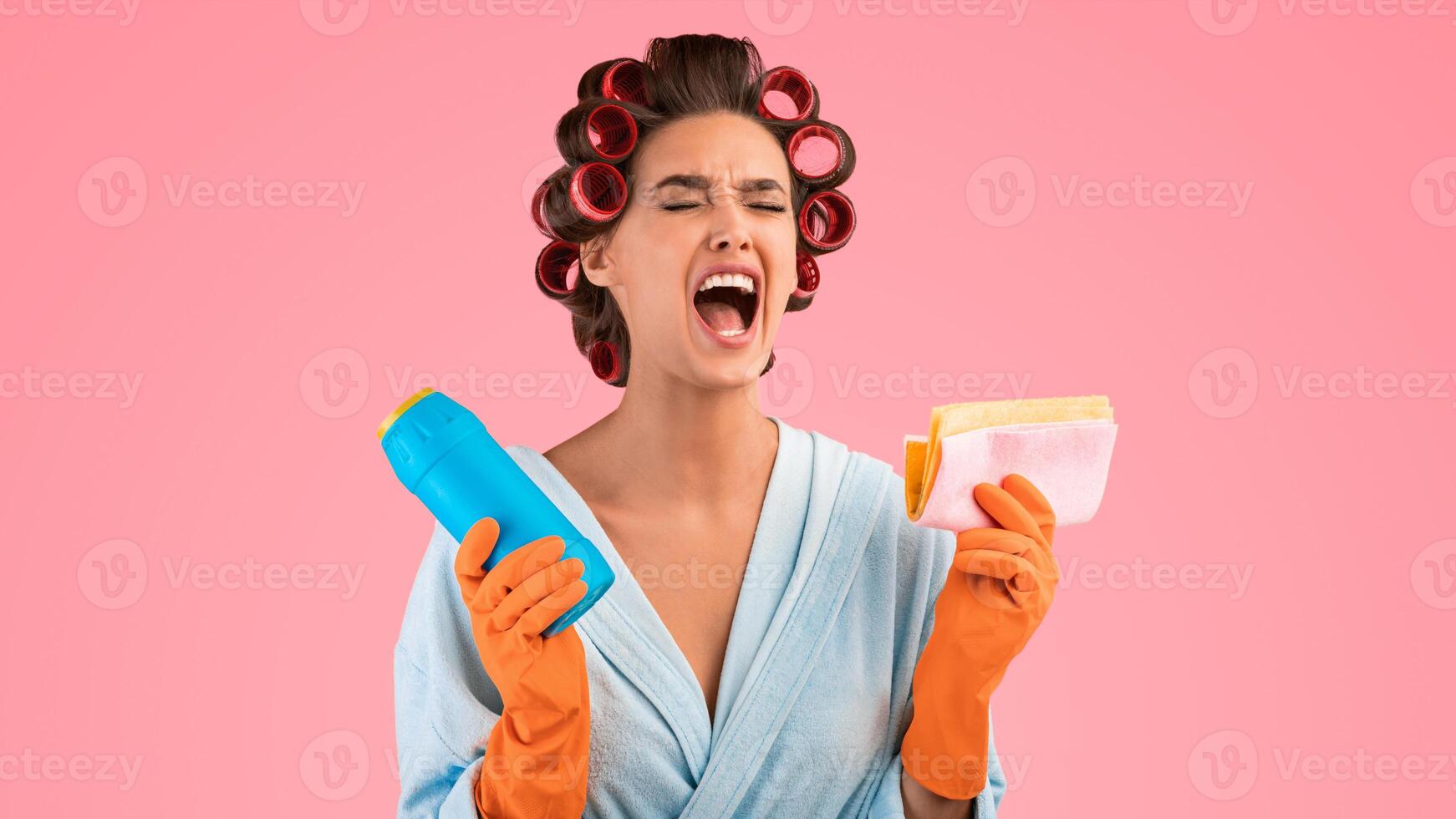 Unhappy Emotional Housewife Shouting Crying Out Loud Holding Detergent Bottle And Sponge Rag Standing On Yellow Studio Background. Housework, Chores, Time To Clean House Concept. Panorama photo