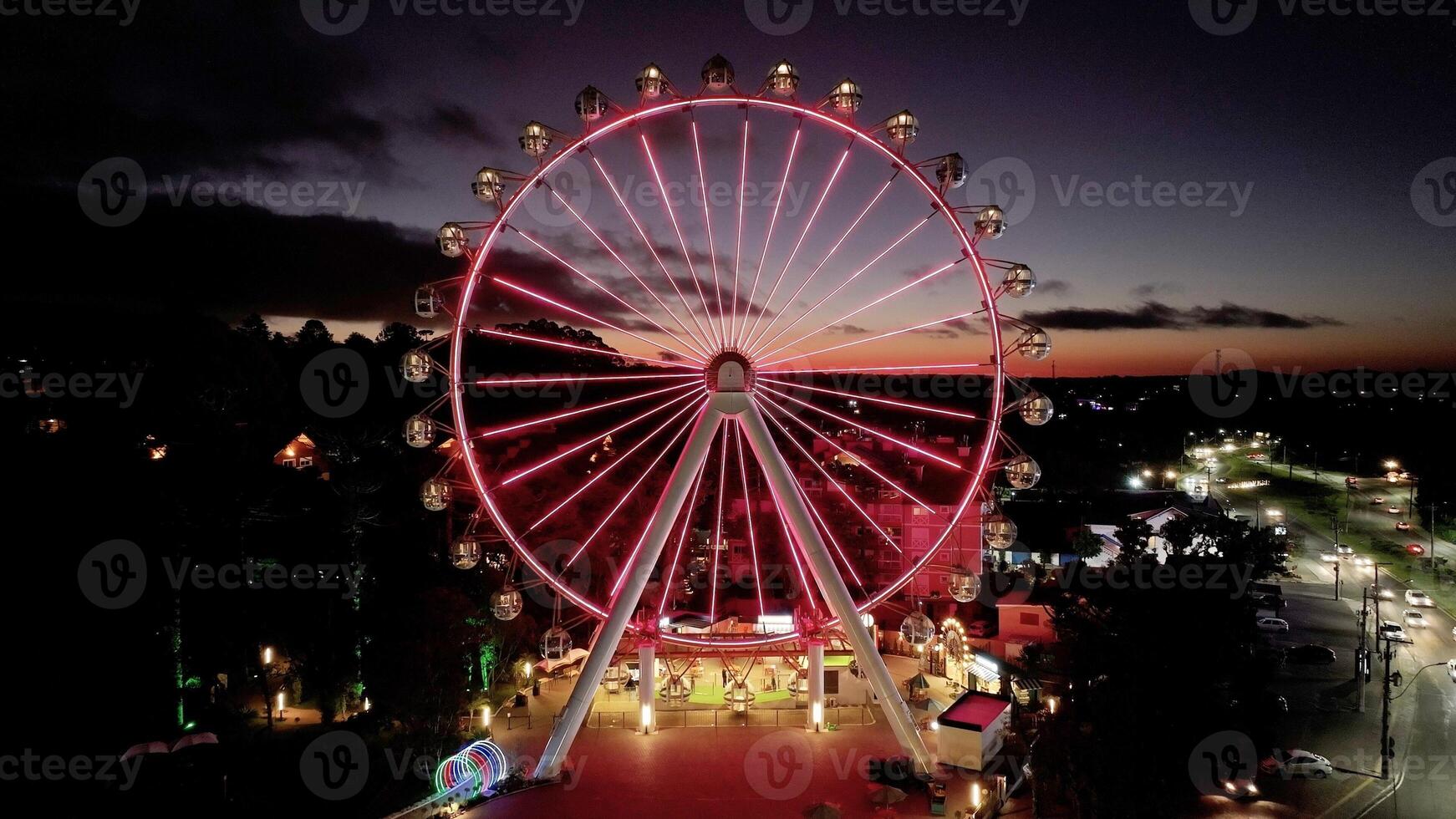 Above view of Illuminated Ferris Wheel in Canela Rio Grande do Sul in Brazil . Neon Trip. photo