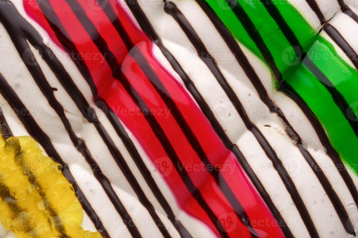 Colorful dessert with chocolate drizzle and vibrant toppings served on a plate photo