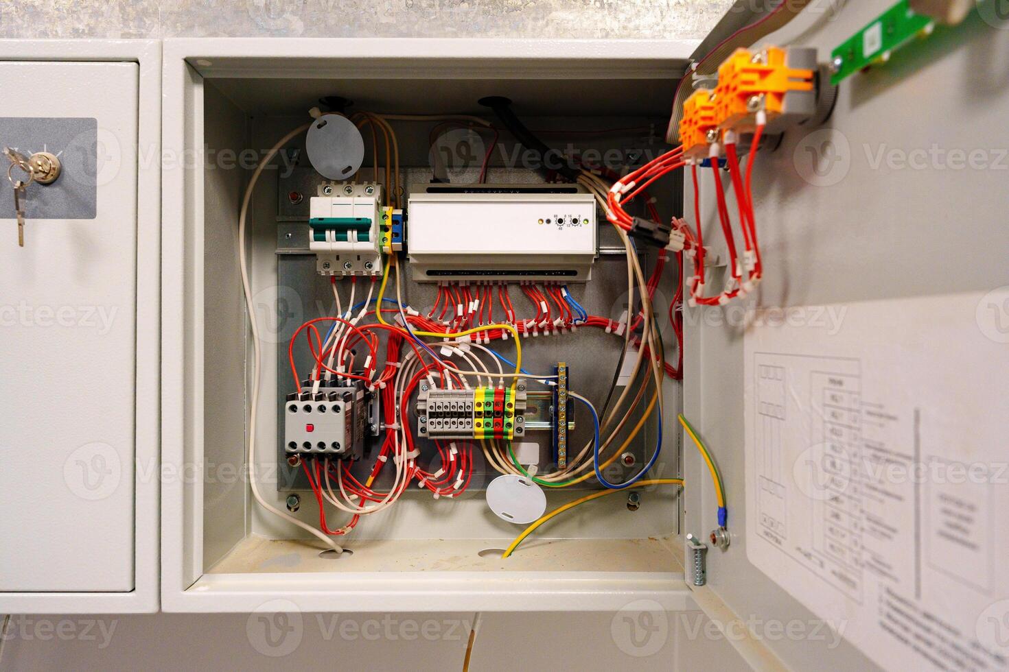 Complex wiring setup inside an electrical control cabinet for industrial applications in a commercial building photo
