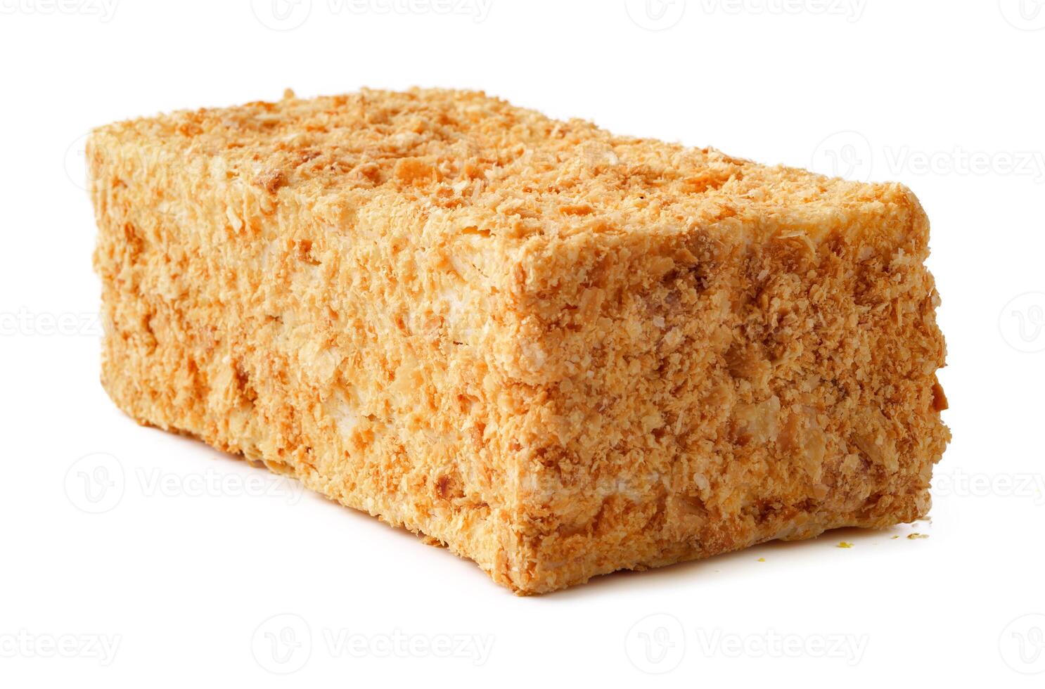 Large rectangular block of sweet dessert made from crushed nuts and syrup displayed on white background photo