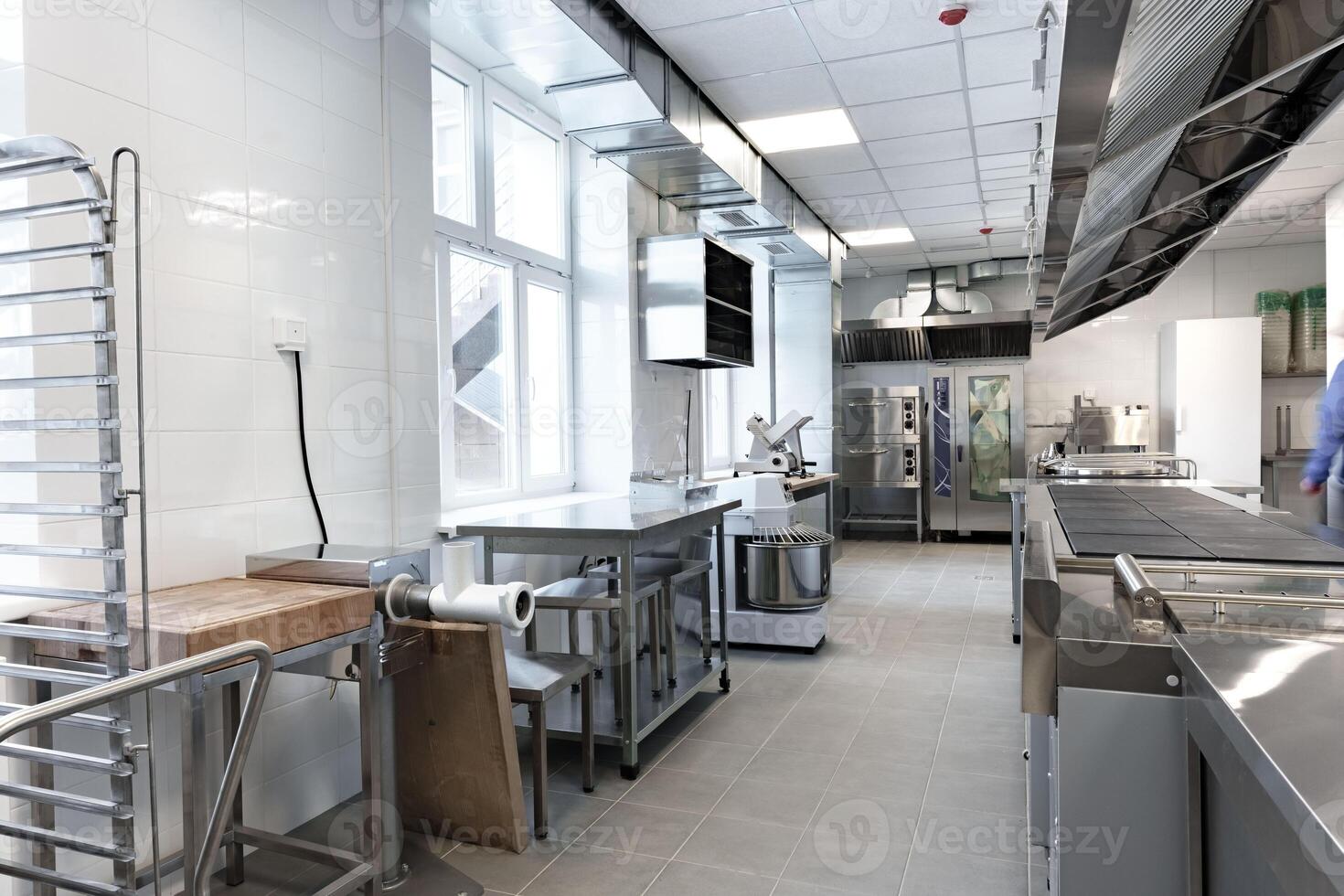 Modern commercial kitchen interior featuring stainless steel appliances and ample workspace for food preparation photo