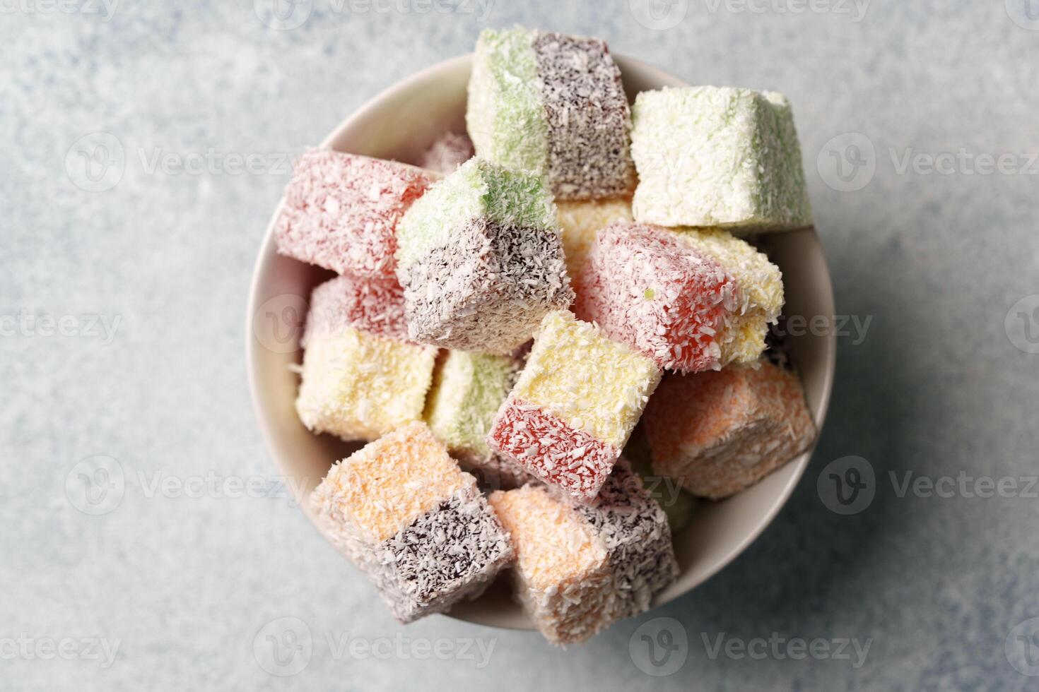 Colorful cubes of sweet confectionery arranged in a bowl ready for sharing at a gathering or celebration photo