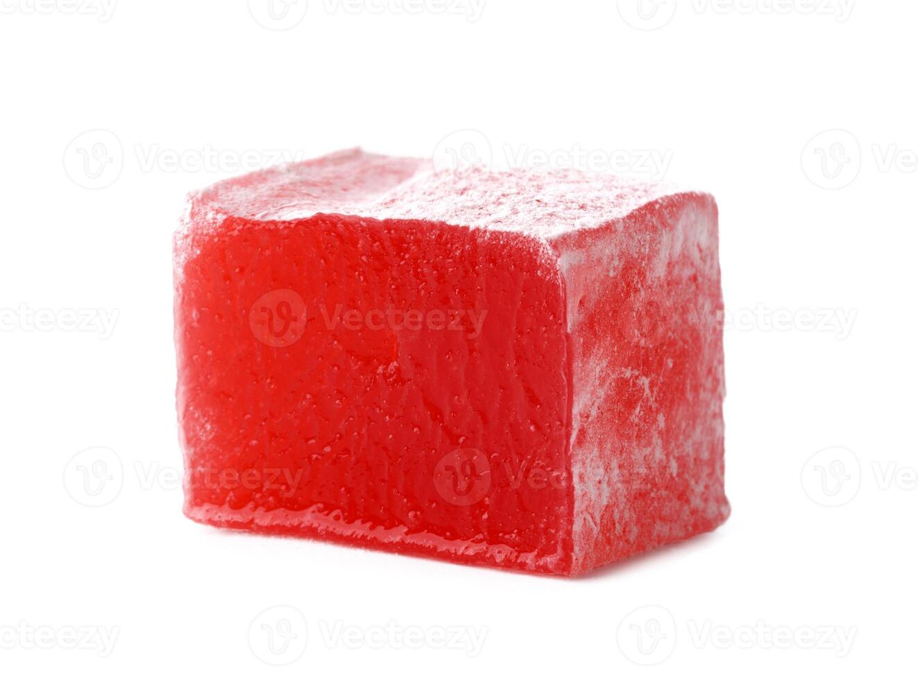 Red jelly cube sits on a white background showcasing its translucent texture and vibrant color photo
