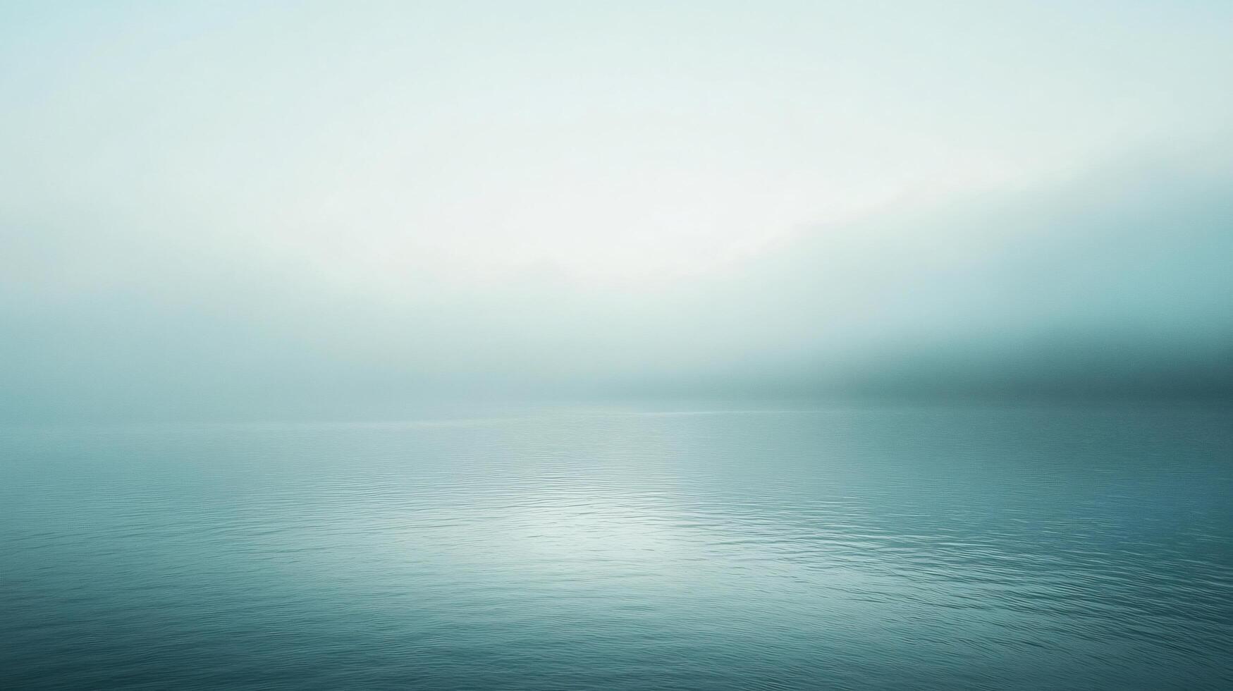 Minimalist seascape featuring light fog hovering over calm water surface during blue hour photo