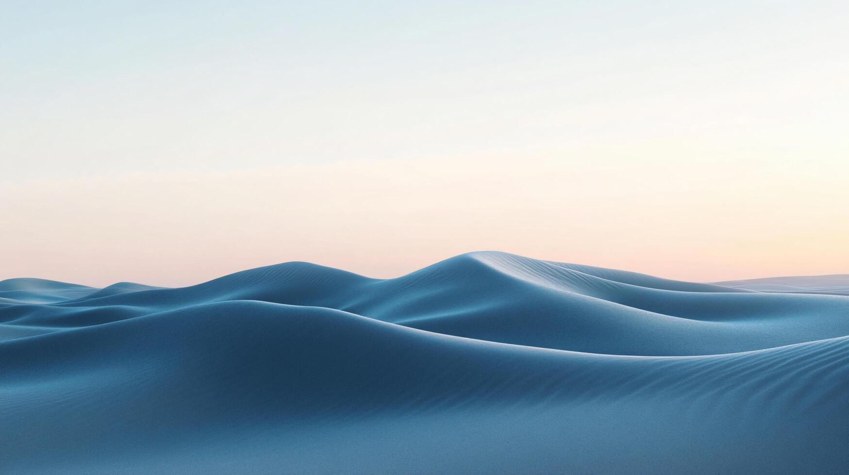 Sand dunes creating a wavy landscape under a clear sky during sunset photo