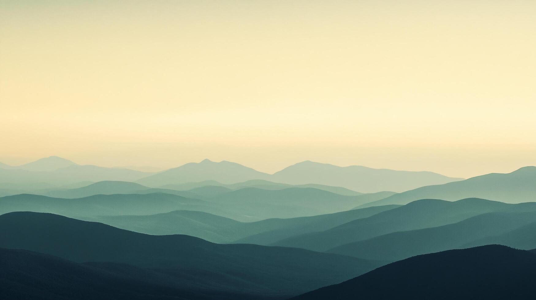 Stunning view of layers of mountains fading into the distance, creating a gradient effect under a warm sunset sky photo