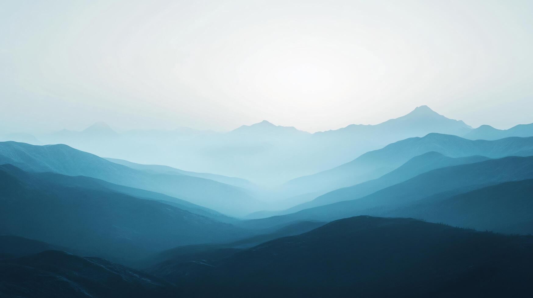 Layers of mountains fading into the distance with atmospheric perspective and a pale sky photo