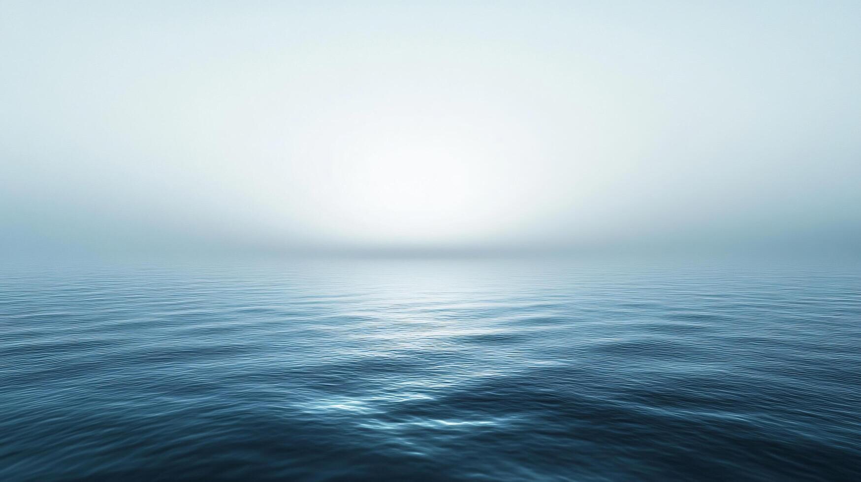 Calm ocean reflecting sunlight on a misty morning, creating a serene and peaceful atmosphere photo