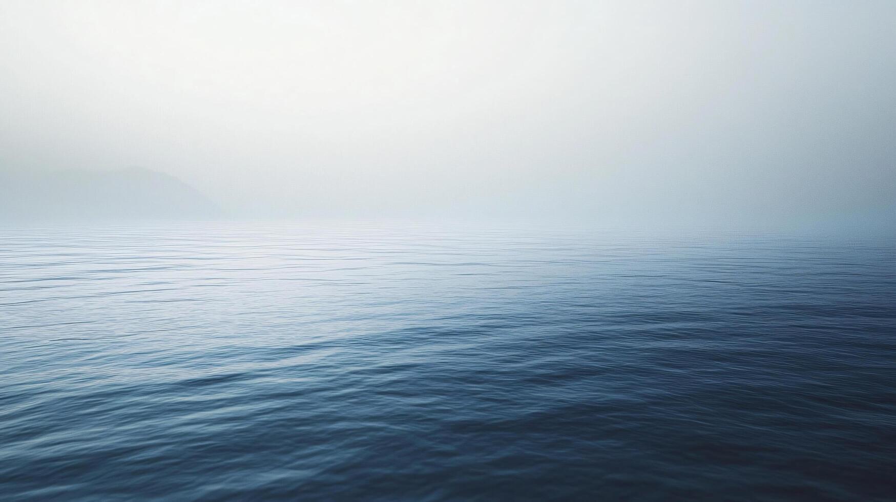 Calm ocean water gradually disappearing into the fog creates a serene and peaceful morning atmosphere photo