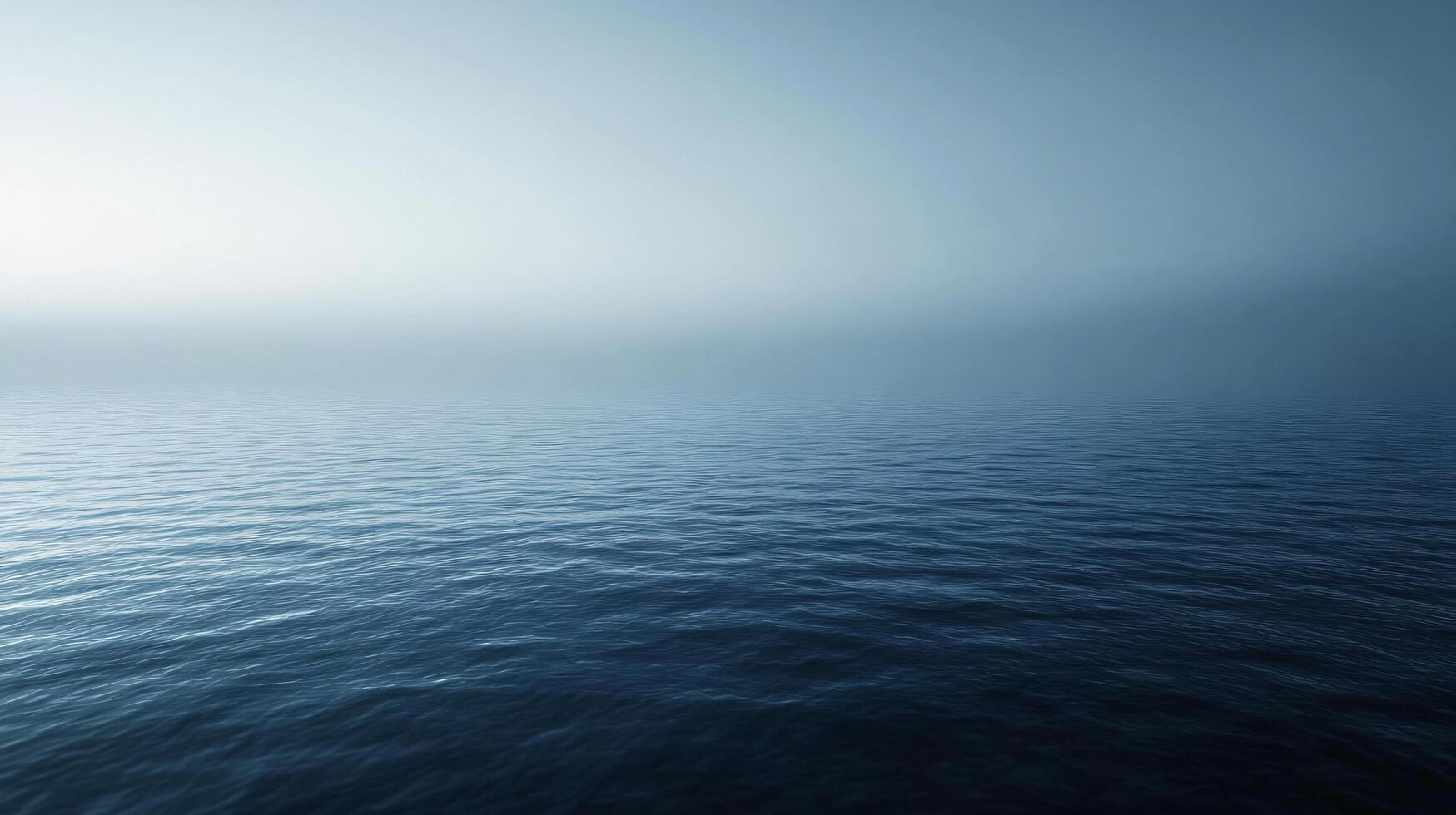 Calm ocean waves meeting a misty sky create a serene and evocative seascape photo