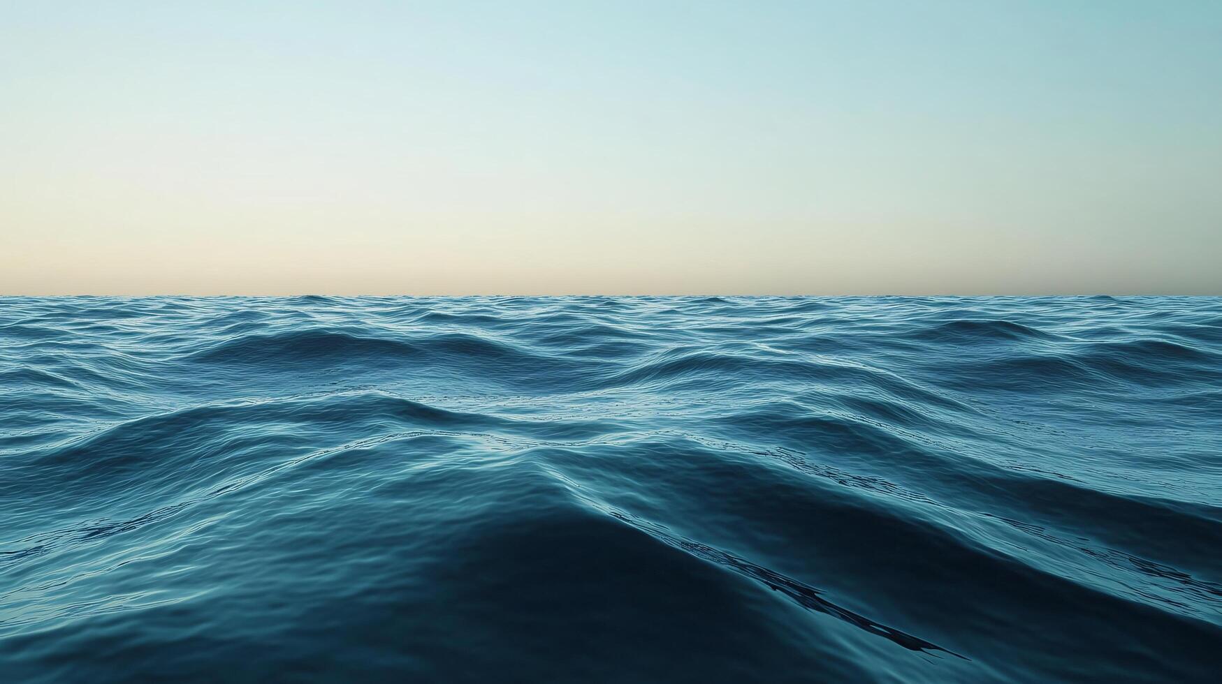 Soft ocean waves are creating a soothing texture under a clear sky during a beautiful sunset photo