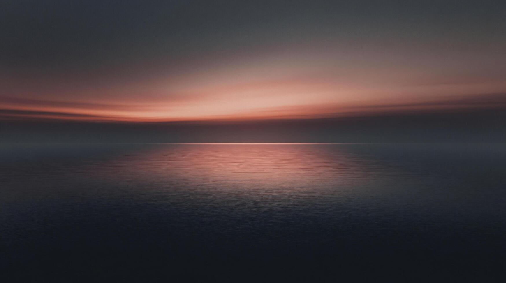 Minimalist seascape showing calm ocean reflecting orange sunset in cloudy sky photo